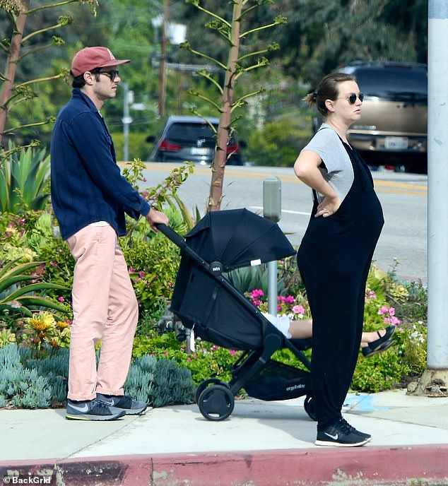 A photo of Pregnant Leighton Meester with husband Adam Brody and first daughter Arlo Day Brody